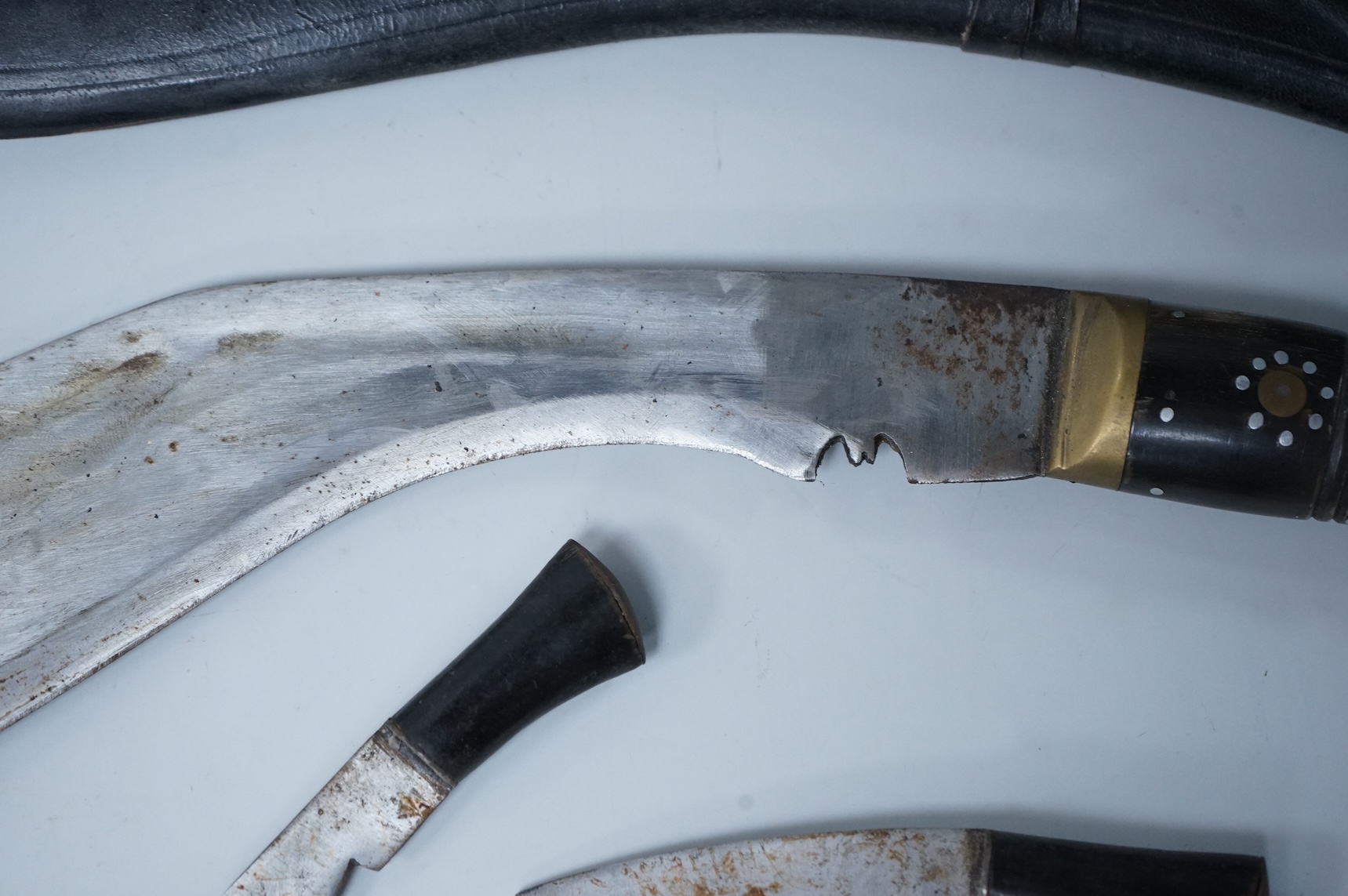 Two kukri knives in leather covered scabbards